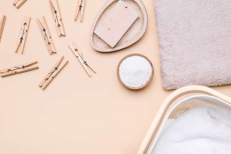 Soap, clothes pegs, towel and laundry detergent on color backgroundの写真素材