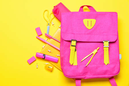 School backpack and stationery on color backgroundの写真素材