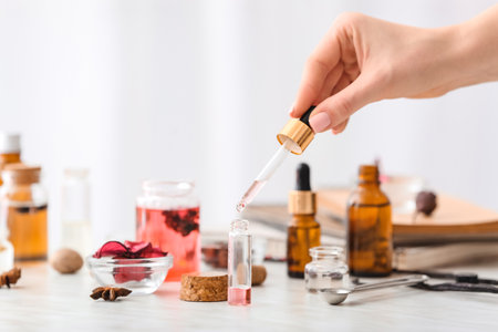 Woman preparing perfume on tableの写真素材