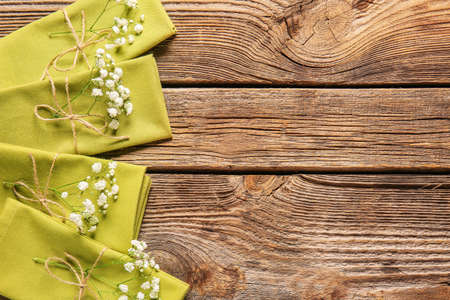 Napkins with floral decor on wooden backgroundの写真素材