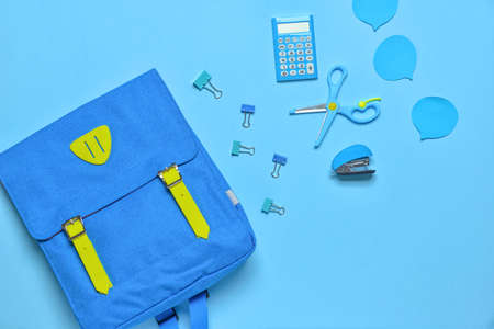 School backpack and stationery on color backgroundの写真素材