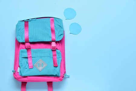 School backpack on color background