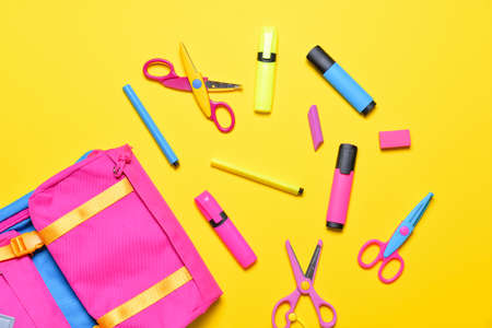 School backpack and stationery on color backgroundの写真素材