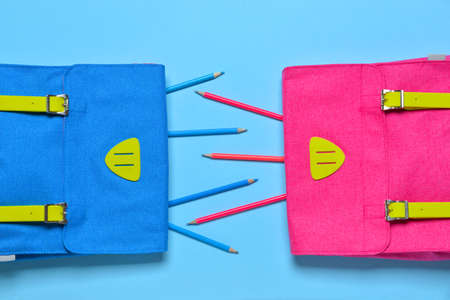 School backpacks and pencils on color backgroundの写真素材