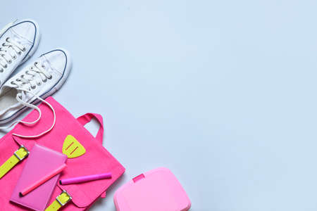 School backpack, stationery and shoes on light backgroundの写真素材