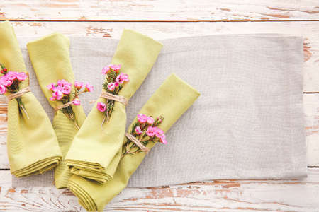 Napkins with floral decor on wooden backgroundの写真素材