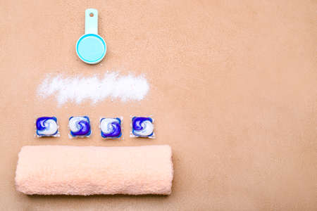 Towel and laundry detergents on color backgroundの写真素材