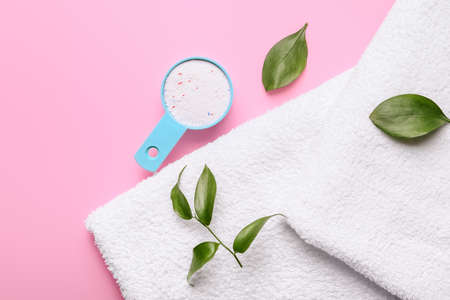 Towels and laundry detergent on color backgroundの写真素材