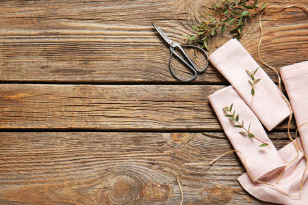 Napkins with floral decor on wooden backgroundの写真素材