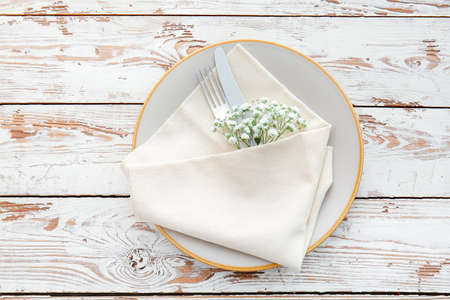 Beautiful table setting with floral decor on wooden backgroundの写真素材