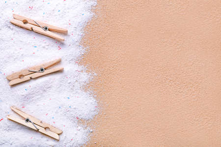 Clothes pegs and laundry detergent on color backgroundの写真素材