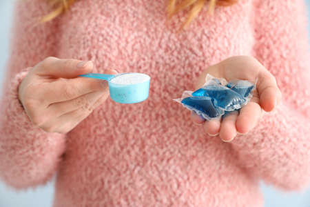 Woman with different detergents, closeupの写真素材