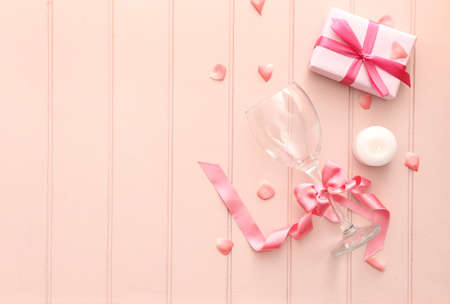 Wine glass with gift box and candle on wooden backgroundの写真素材