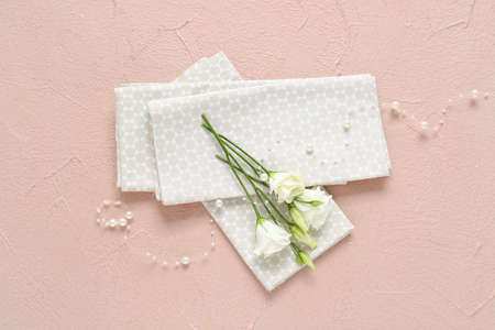 Napkins and flowers on color backgroundの写真素材