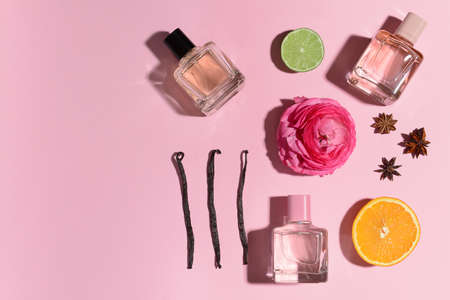 Beautiful composition with perfume bottles on color backgroundの写真素材