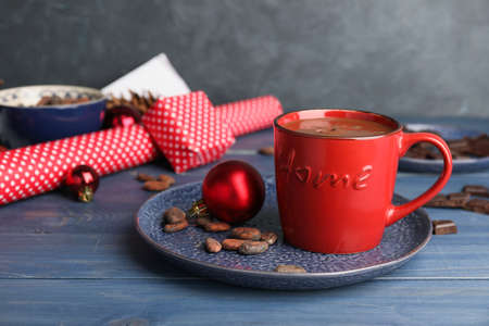 Cup of hot chocolate and Christmas decor on tableの写真素材