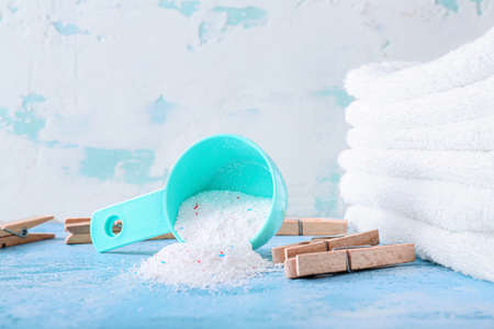 Laundry detergent with towels and pegs on color backgroundの写真素材