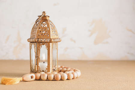 Muslim lamp and tasbih on tableの写真素材