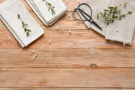 Napkins with floral decor on wooden backgroundの写真素材