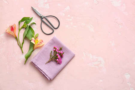 Napkin with floral decor prepared for table setting on color backgroundの写真素材