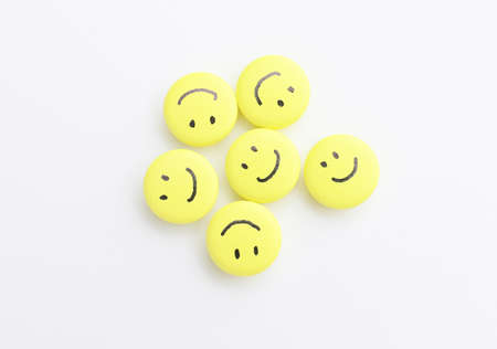 Pills with drawn happy faces on white backgroundの写真素材