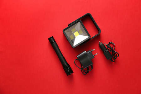 Modern flashlights with battery chargers on color backgroundの写真素材