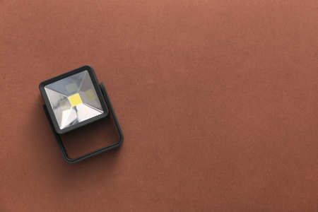 Modern flashlight on color backgroundの写真素材