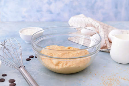 Bowl with sweet dough on color backgroundの写真素材