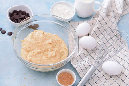 Bowl with sweet dough and products on color backgroundの写真素材