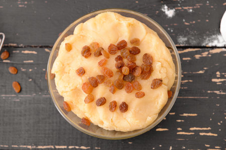 Bowl with sweet dough on tableの写真素材