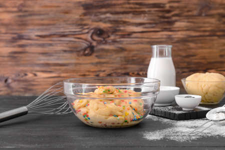 Bowl with sweet dough on table