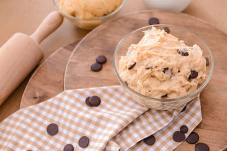 Bowl with sweet dough on tableの写真素材