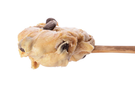 Spoon with sweet dough on white backgroundの写真素材