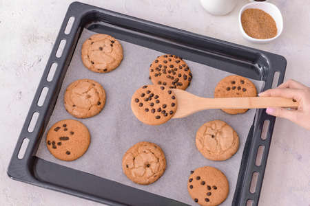 Woman with freshly baked sweet cookies on tray cookies, top viewの写真素材
