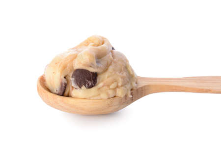 Spoon with sweet dough on white backgroundの写真素材