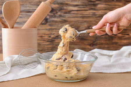 Woman preparing sweet dough at tableの写真素材