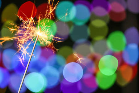 Beautiful Christmas sparkler against defocused lightsの写真素材