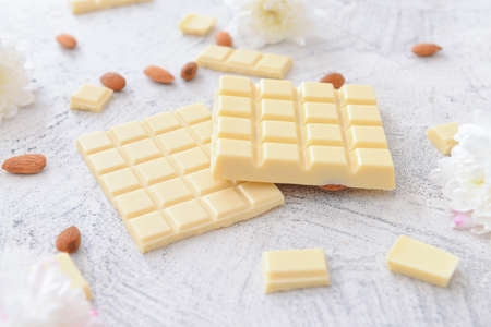 Sweet white chocolate with almond on tableの写真素材