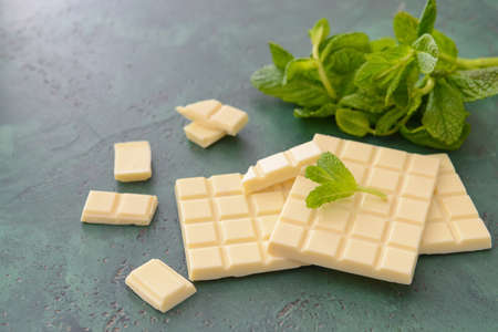 Sweet white chocolate with mint on tableの写真素材