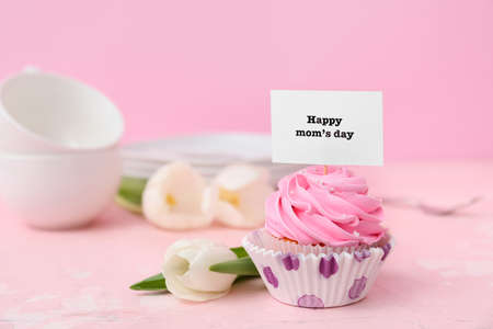 Tasty cupcake for Mother's Day on color backgroundの写真素材