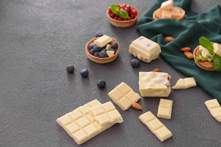 Sweet white chocolate with nuts and berries on tableの写真素材
