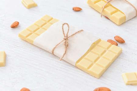 Sweet white chocolate with almond on tableの写真素材