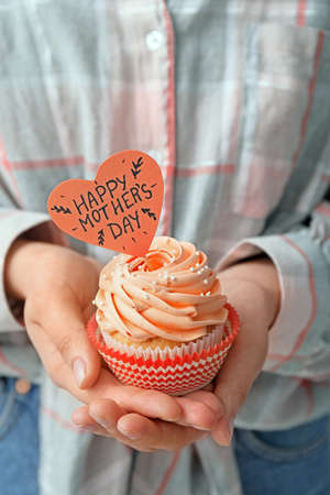 Woman with tasty cupcakes for Mother's Day, closeupの写真素材