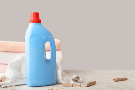 Laundry detergent with towels and pegs on tableの写真素材
