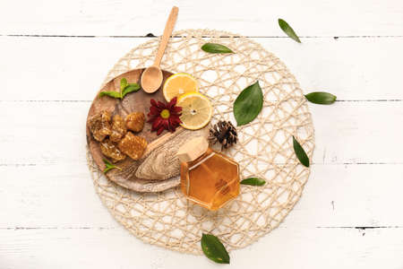 Jar of sweet honey with lemon on wooden backgroundの写真素材