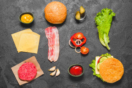 Ingredients for tasty burger on dark backgroundの写真素材