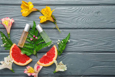 Beautiful composition with perfume bottles on wooden background