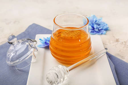 Jar of sweet honey on tableの写真素材