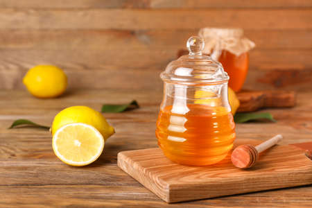 Jar of sweet honey on wooden backgroundの写真素材