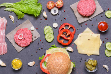 Ingredients for tasty burger on dark backgroundの写真素材